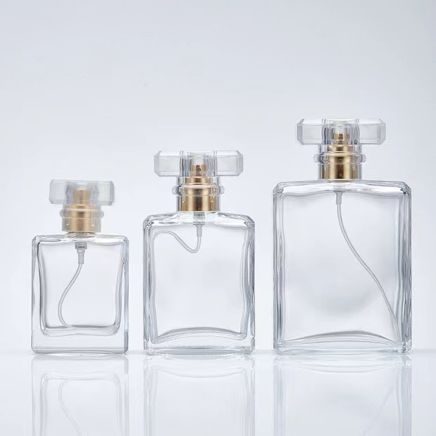 Botella de perfume de cristal transparente con forma de rectángulo de 100 ml con tapa de acrílico 